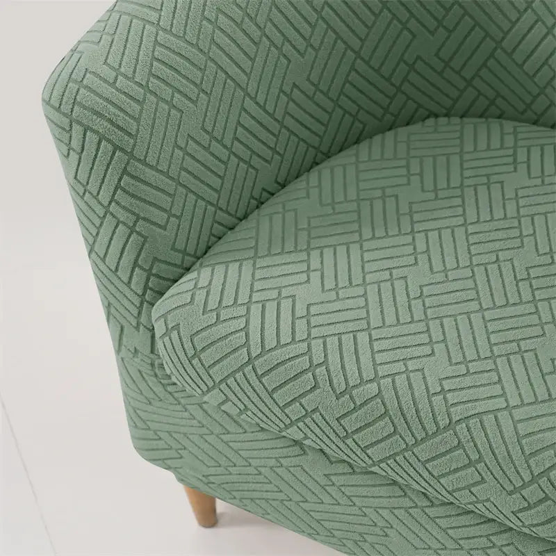 A soft mint green herringbone jacquard elastic armchair slipcover with subtle woven texture for living room decor