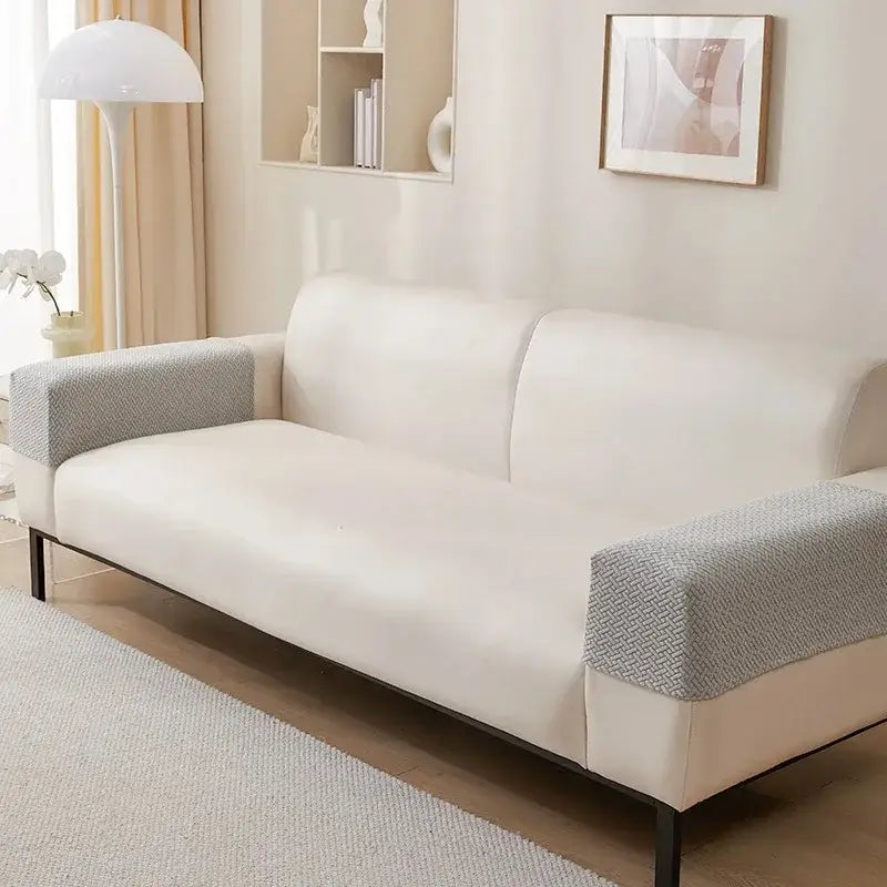 Cream-colored sofa with textured gray herringbone weave fleece armrest covers and sleek black metal legs for living room protection