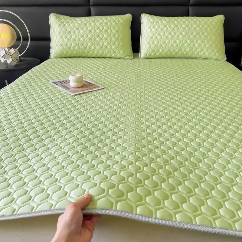 Light green honeycomb-patterned cooling bed sheet with gray border from hexagonal quilted pink and gray sheet set