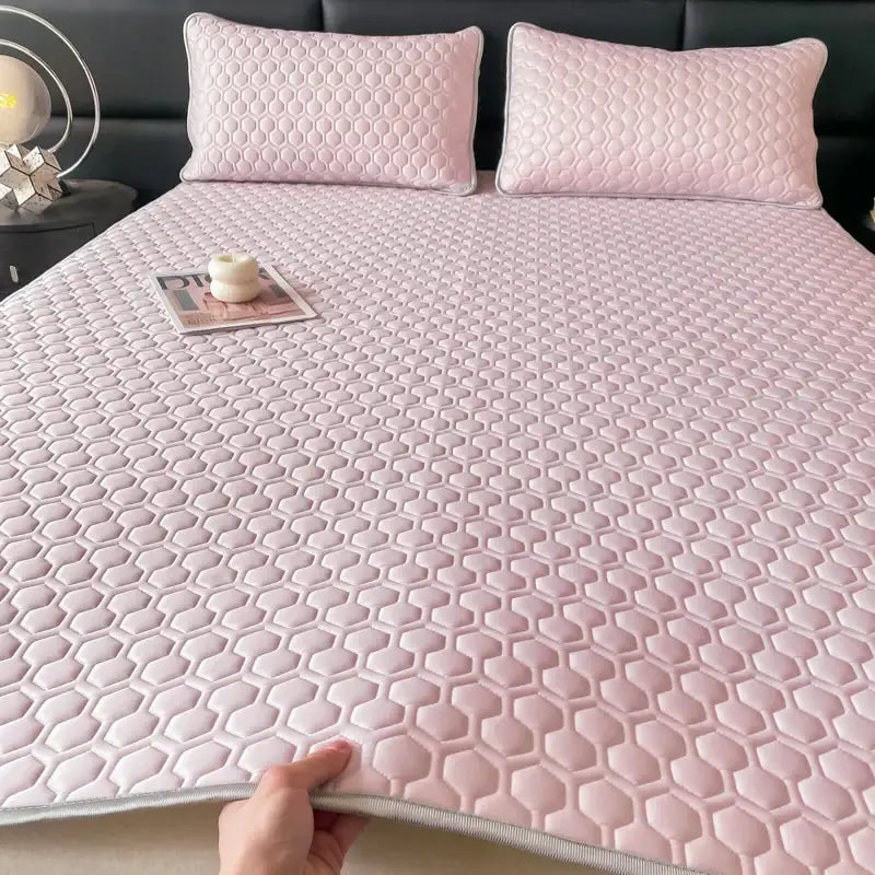 Pink hexagonal quilted bed sheet set with subtle sheen and light gray border for cooling bedroom comfort