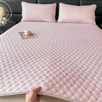 Pink hexagonal quilted bed sheet set with subtle sheen and light gray border for cooling bedroom comfort