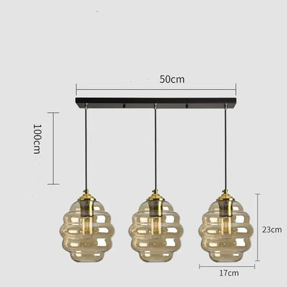Modern honeycomb pendant light with amber glass shades and brass accents perfect for kitchen dining decorbites colorful glass