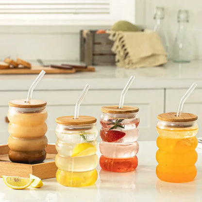 Clear glass honeycomb creative glass cup set with bamboo lids and silicone straws filled with colorful beverages