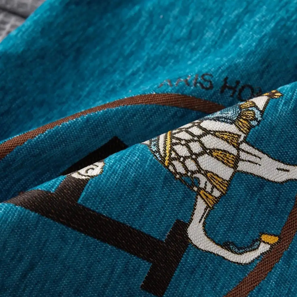 Teal fabric horse embroidered jacquard pillow cover with white and gold bird design and brown woven bands for decorbites decor