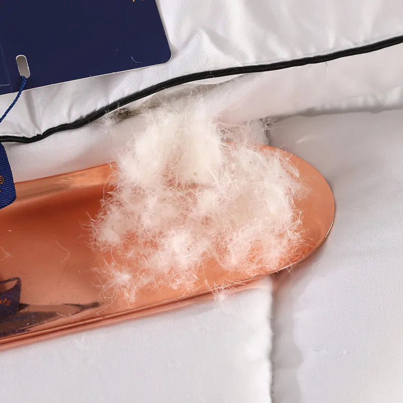 White fluffy down filling on a copper tray for a lightweight comfortable breathable hotel style winter quilt blanket