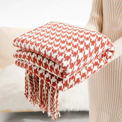 Cozy folded decorbites houndstooth throw blanket with classic red and white pattern and matching fringed edges for living room decor