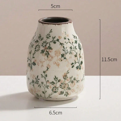 A white crackle vase ceramic with delicate green beige floral patterns and a flared rim for home decoration