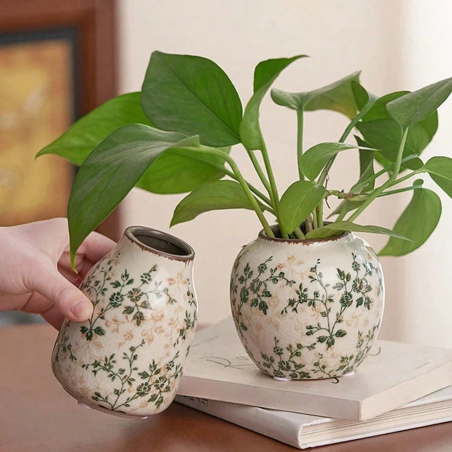 Two handmade ice crackle ceramic vases with green floral patterns on cream glaze for flower display at home or office