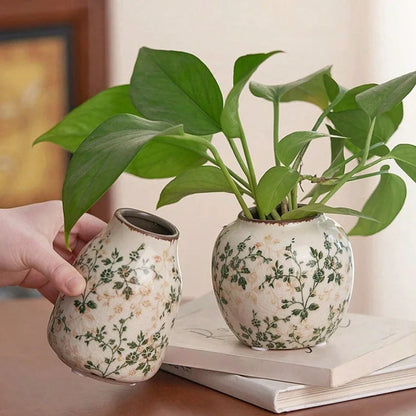 Two handmade ice crackle ceramic vases with green floral patterns on cream glaze for flower display at home or office