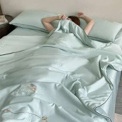 A soft mint green satin duvet set with delicate embroidery and black piping from decorbites ice rayon summer quilt collection