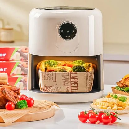 White air fryer with digital control panel and transparent lid featuring a basket lined with grease-resistant baking paper