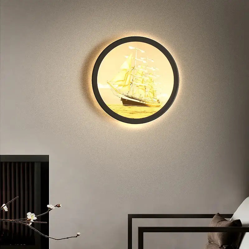 Industrial acrylic round wall lamp with black frame and warm illumination featuring sailing ship decorbites industrial acrylic design