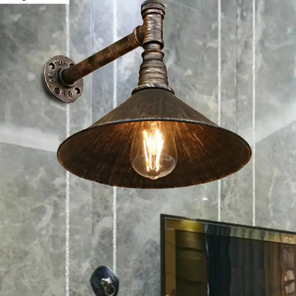 DecorBites™ farmhouse style wall sconce with antique brass cone and pipe arm featuring exposed filament bulb