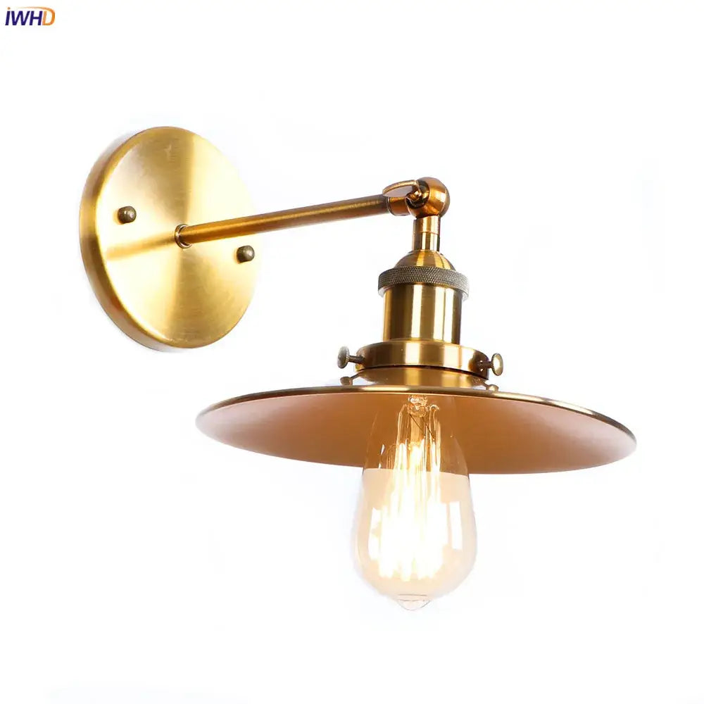 Industrial antique gold rustic wall light with brass finish, circular backplate, articulated arm, and exposed filament bulb
