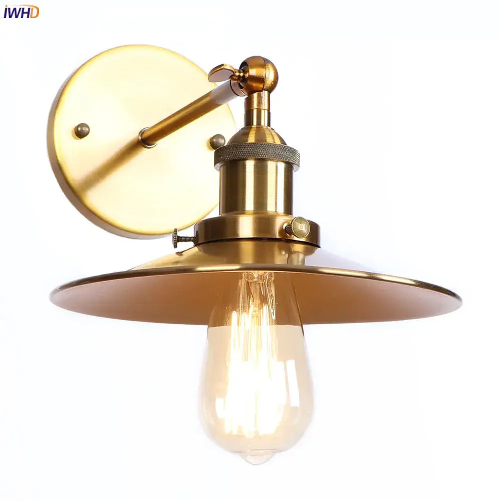 Brass-finished industrial-style wall light with wide flat shade and exposed filament bulb decorbites antique gold rustic design