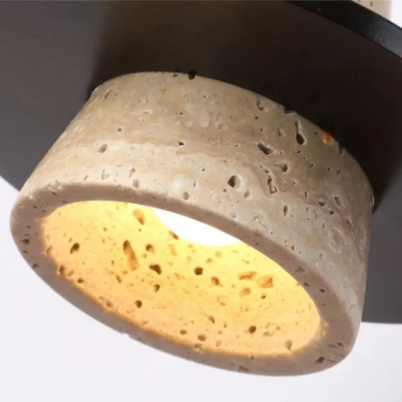 Rounded beige concrete wall lamp with textured exterior and warm yellow glow for bedroom decorbites led wall lighting