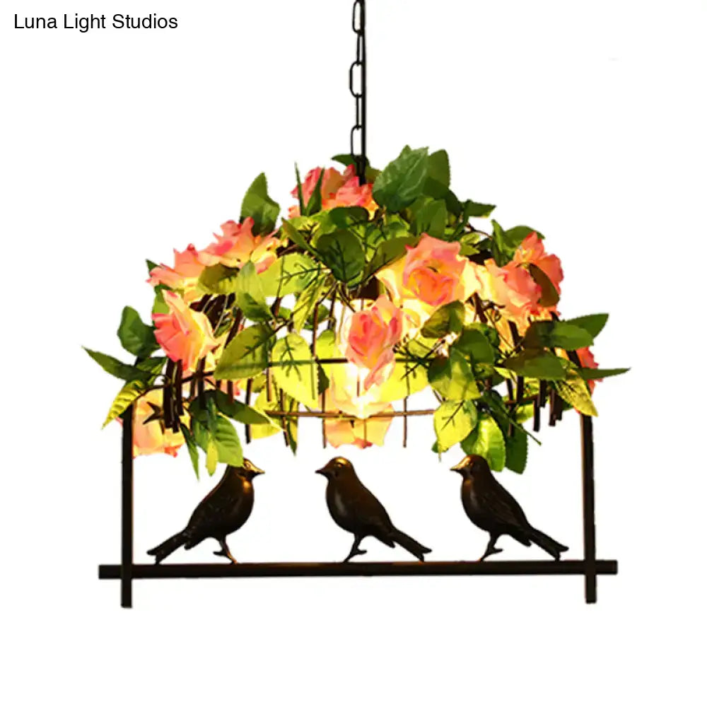 Black metal industrial birdcage island pendant with three birds and pink yellow rose cascade in iron black finish