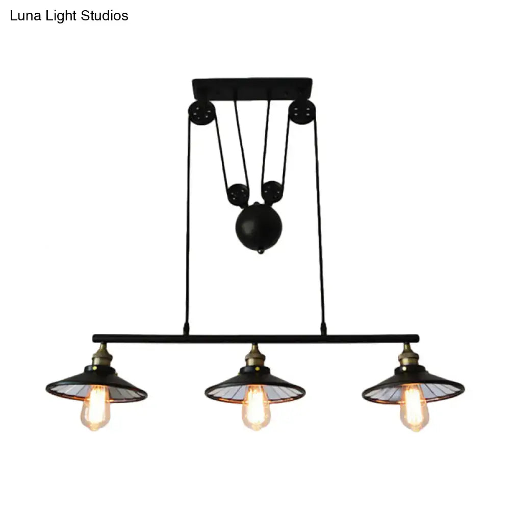 Industrial black three-bulb pendant light with pulley design for kitchen island illumination