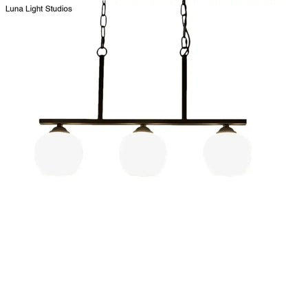 Black metal pendant light with three opal glass globe shades ideal for dining room lighting by DecorBites™