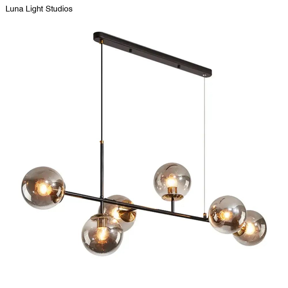Modern black metal 6-light island pendant with smoked glass globe bulbs and amber milky white gradient shades