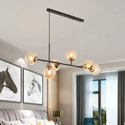 Modern black metal 6-light island pendant with clear glass globes and gold-toned fixtures for stylish lighting