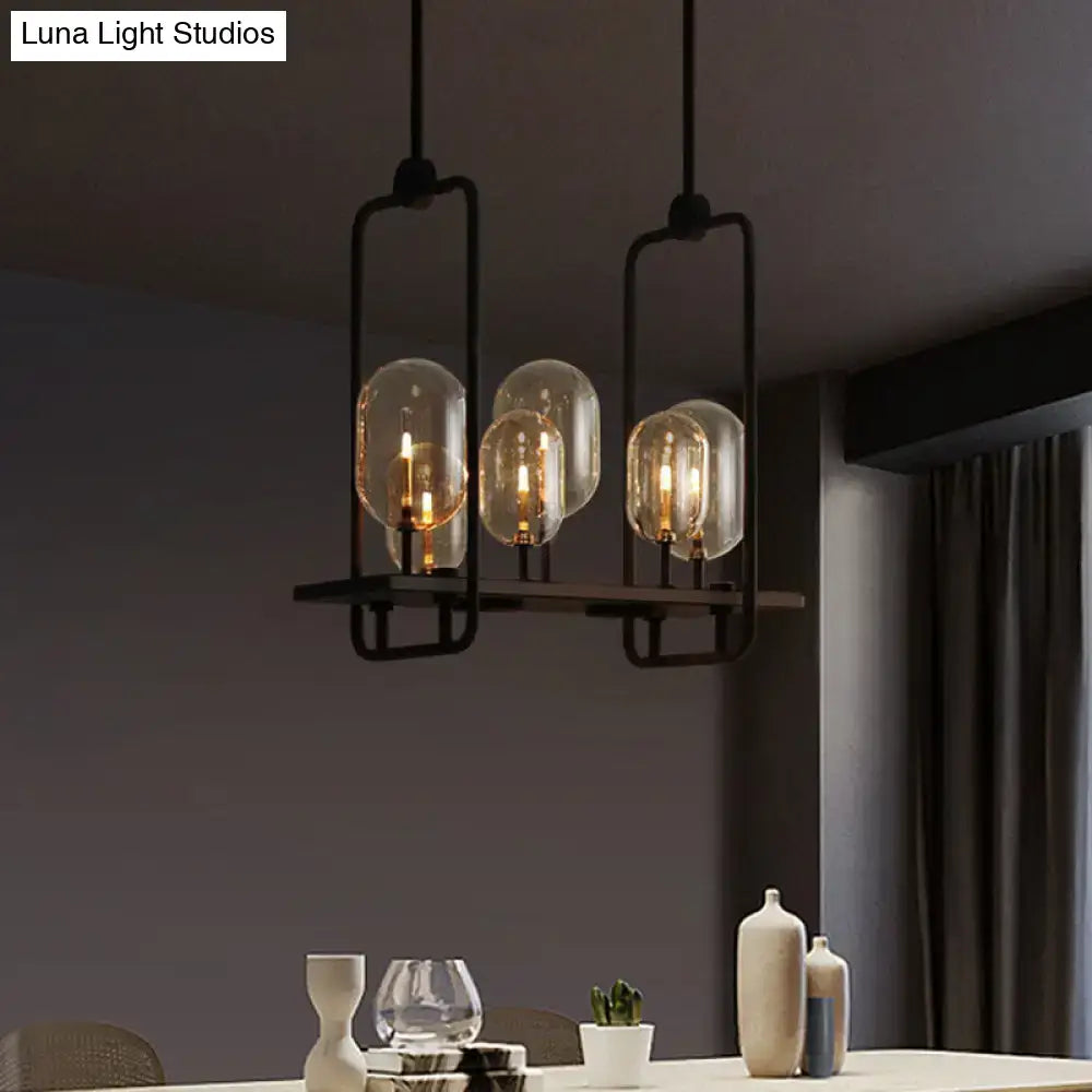 Black metal industrial pendant light with three clear amber glass bulbs featuring adjustable chain cord length and fixture height