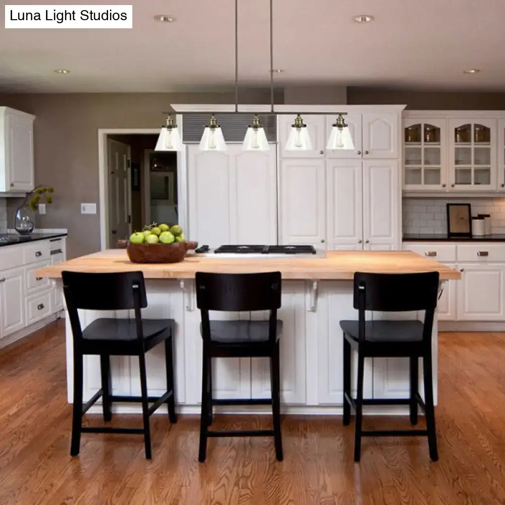 White kitchen island with light wood countertop and three black stools under decorbites™ industrial black cone shade clear glass 5-head island chandelier e26 e27