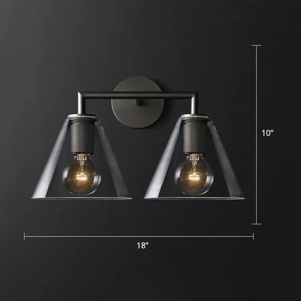 Industrial black and brass wall lamp with clear glass conical shades featuring two exposed filament bulbs fixture type