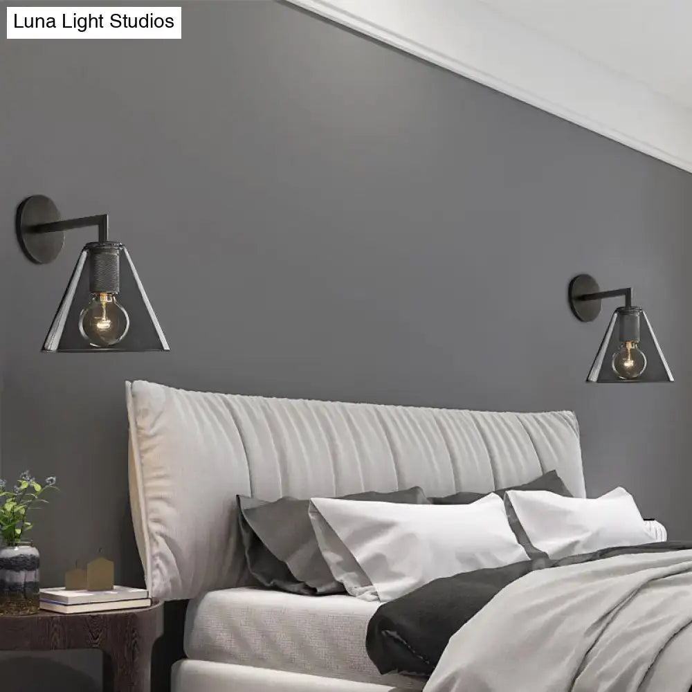 Industrial black and brass wall lamp with clear glass triangular shade and exposed filament bulb fixture type
