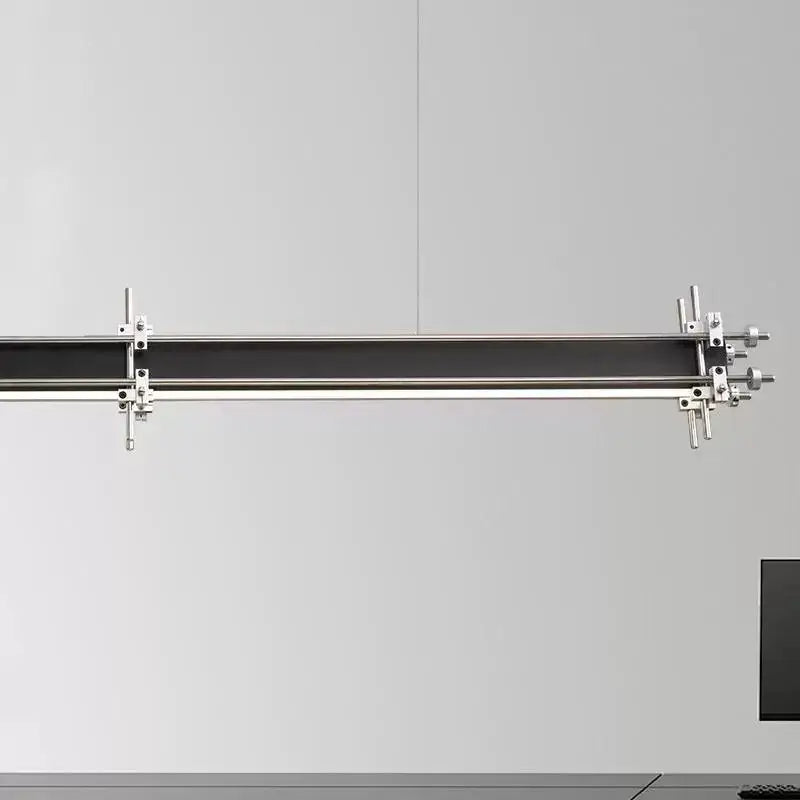 A sleek industrial style pendant chandelier with a black bar and polished chrome fixtures for dining room decorbites