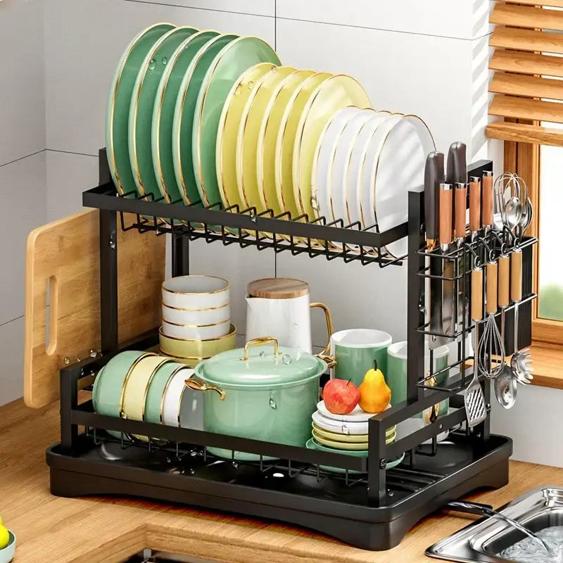 Black metal and gold two tier kitchen storage rack with organized gold-trimmed plates and utensils for tier kitchen storage