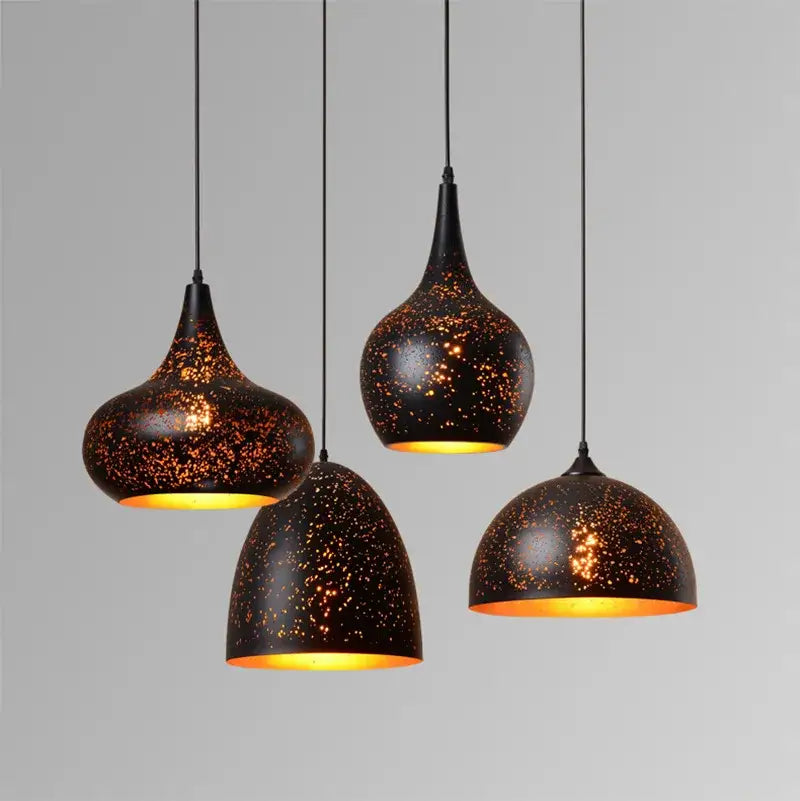 Set of four black speckled etched wrought iron pendant lights with warm gold interiors for dining room decorbites chandelier