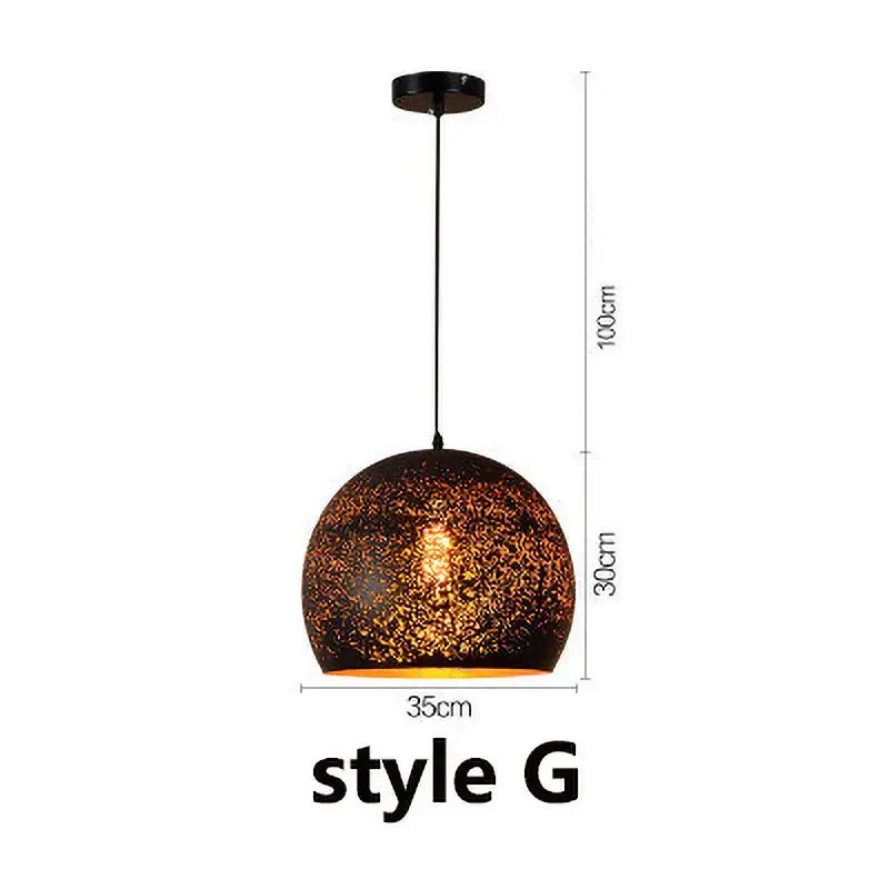 Industrial black and gold etched wrought iron chandelier with a spherical textured dark brown and gold mosaic pendant light