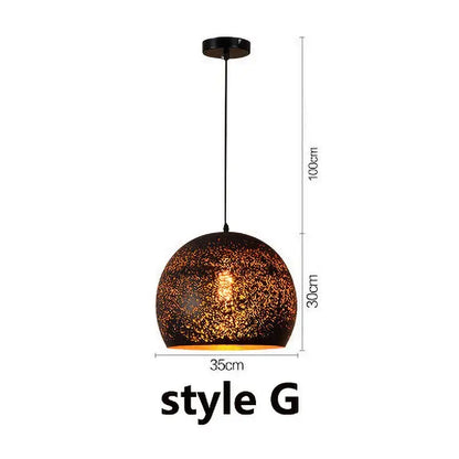 Industrial black and gold etched wrought iron chandelier with a spherical textured dark brown and gold mosaic pendant light