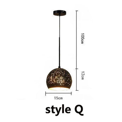 A sleek black pendant light with a speckled glass shade in an industrial black and gold etched wrought iron chandelier