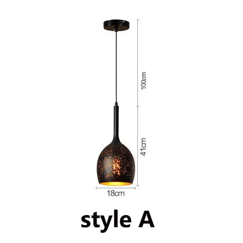 Industrial black and gold etched wrought iron chandelier featuring a black pendant light with speckled textured glass shade and metal stem