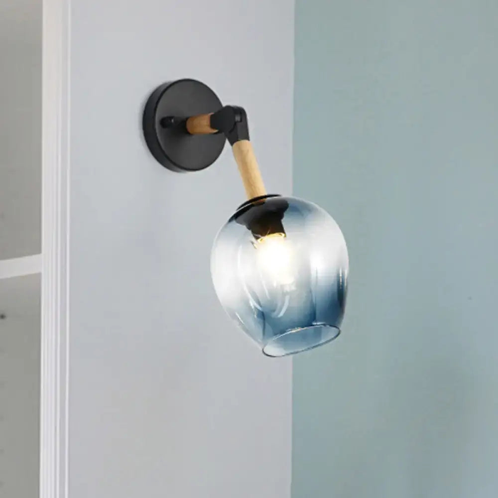 Industrial black and ocean blue wall sconce with blue gradient glass globe, black metal base, and wooden arm for bedroom lighting