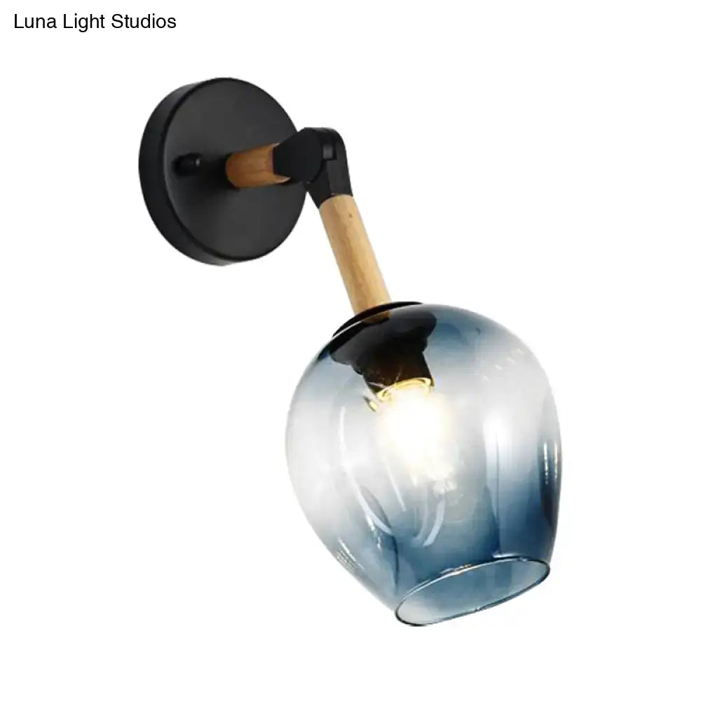 Industrial black and ocean blue wall sconce with blue gradient glass globe, black metal base, and wooden arm for bedroom lighting