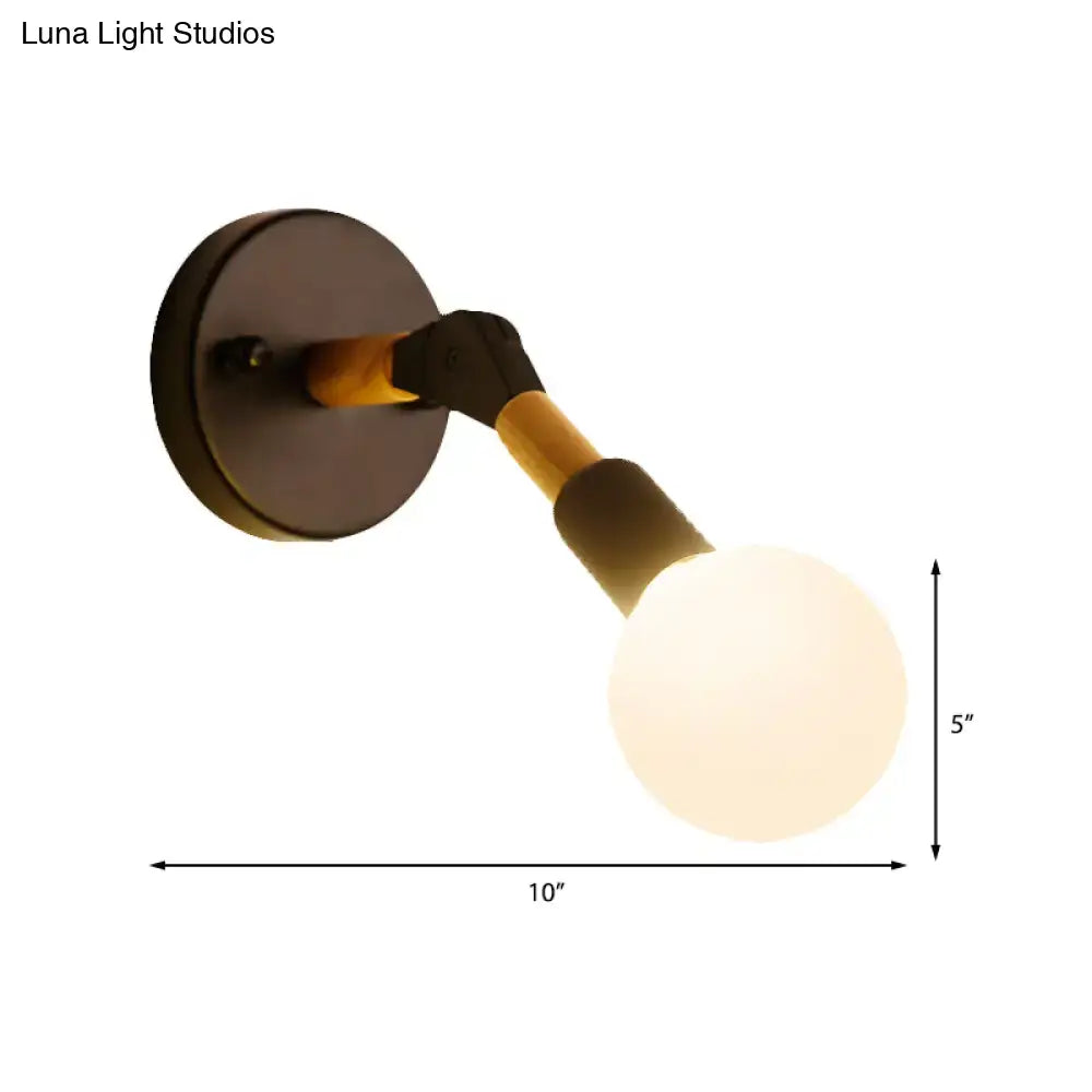 Industrial black and ocean blue wall sconce with wooden accents and a warm-toned spherical bulb for bedroom lighting
