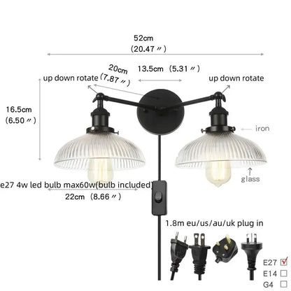 Industrial black iron wall light fixture with two adjustable arms and ribbed glass shades for bedroom use