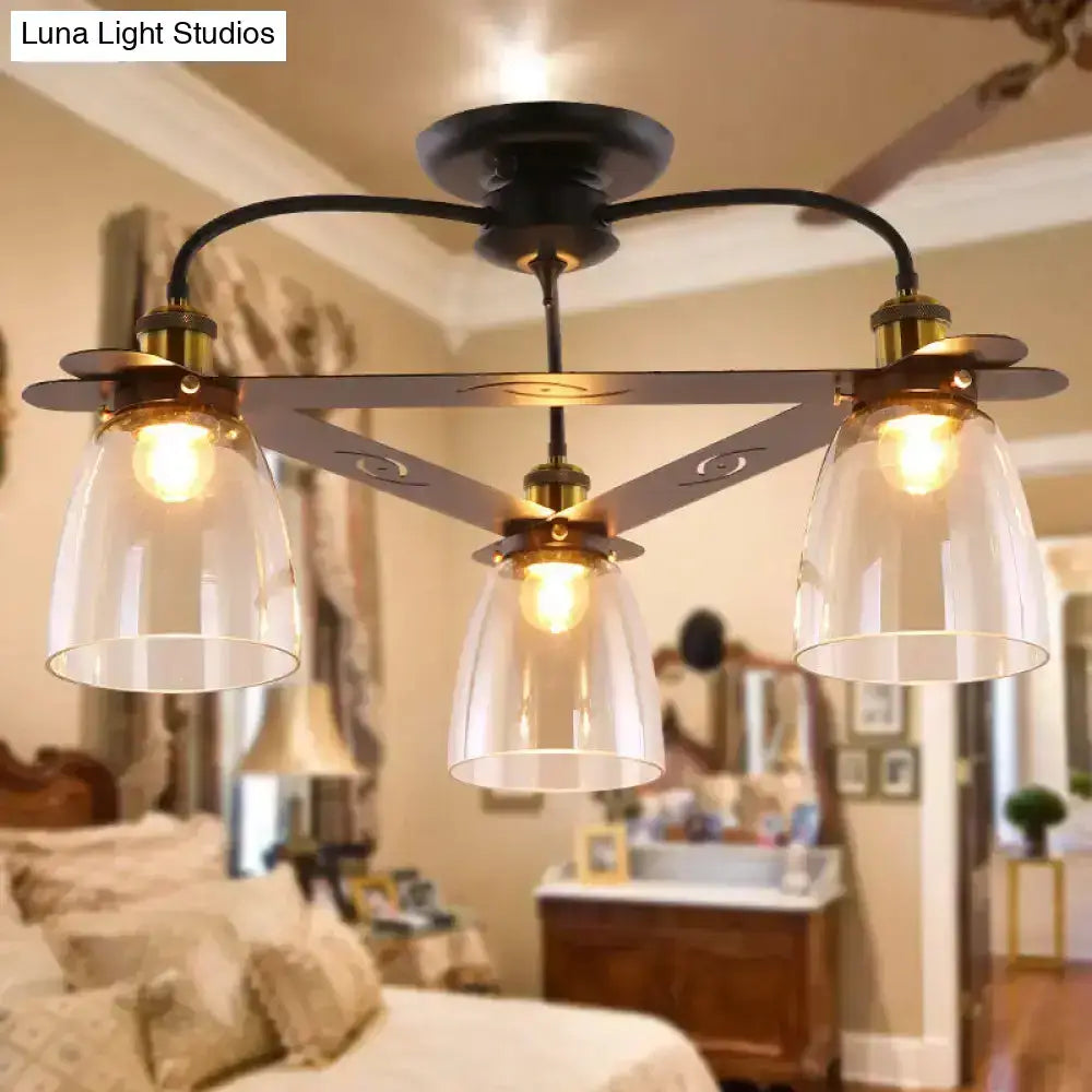 Black metal ceiling lamp with cognac glass bell shades and aged brass accents ideal for living room lighting