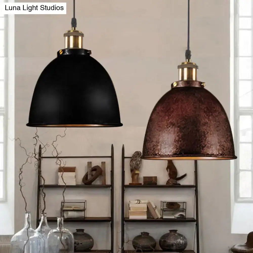 Two pendant lamps featuring antique style dome shades in matte black and textured copper with brass hardware