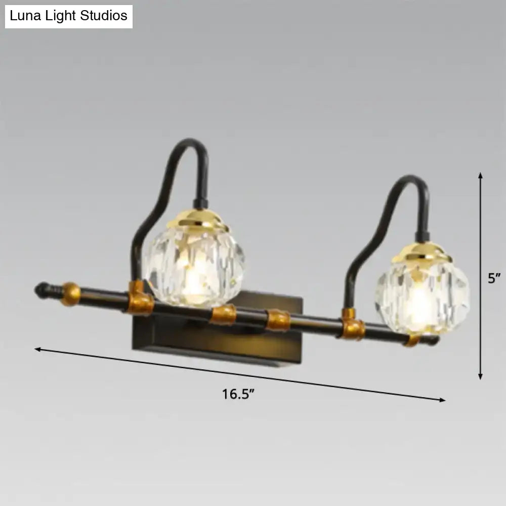 Industrial black and brass hexagon vanity wall lamp with crystal prisms and two globe shades designed for vanity use