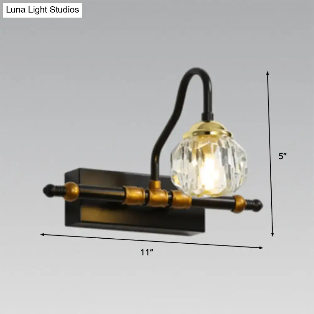 Industrial black and brass hexagon vanity wall lamp with crystal prisms and a faceted crystal globe on a curved arm