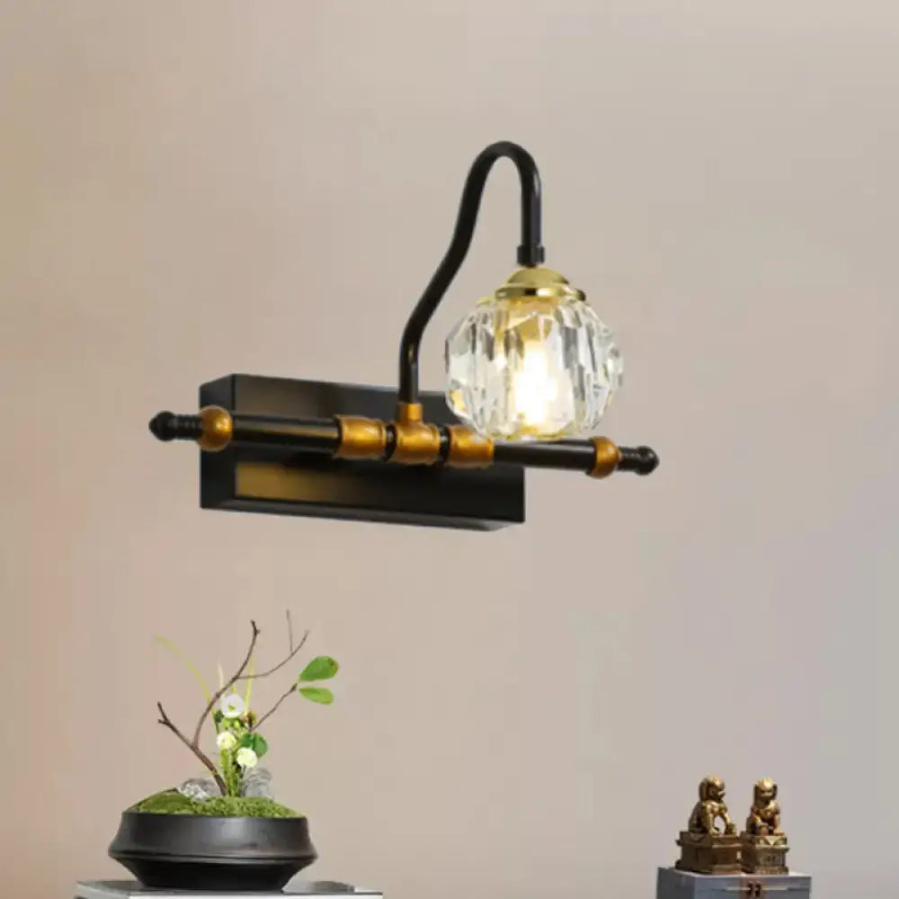 Industrial black and brass hexagon vanity wall lamp with faceted crystal prisms and a crystal globe bulb