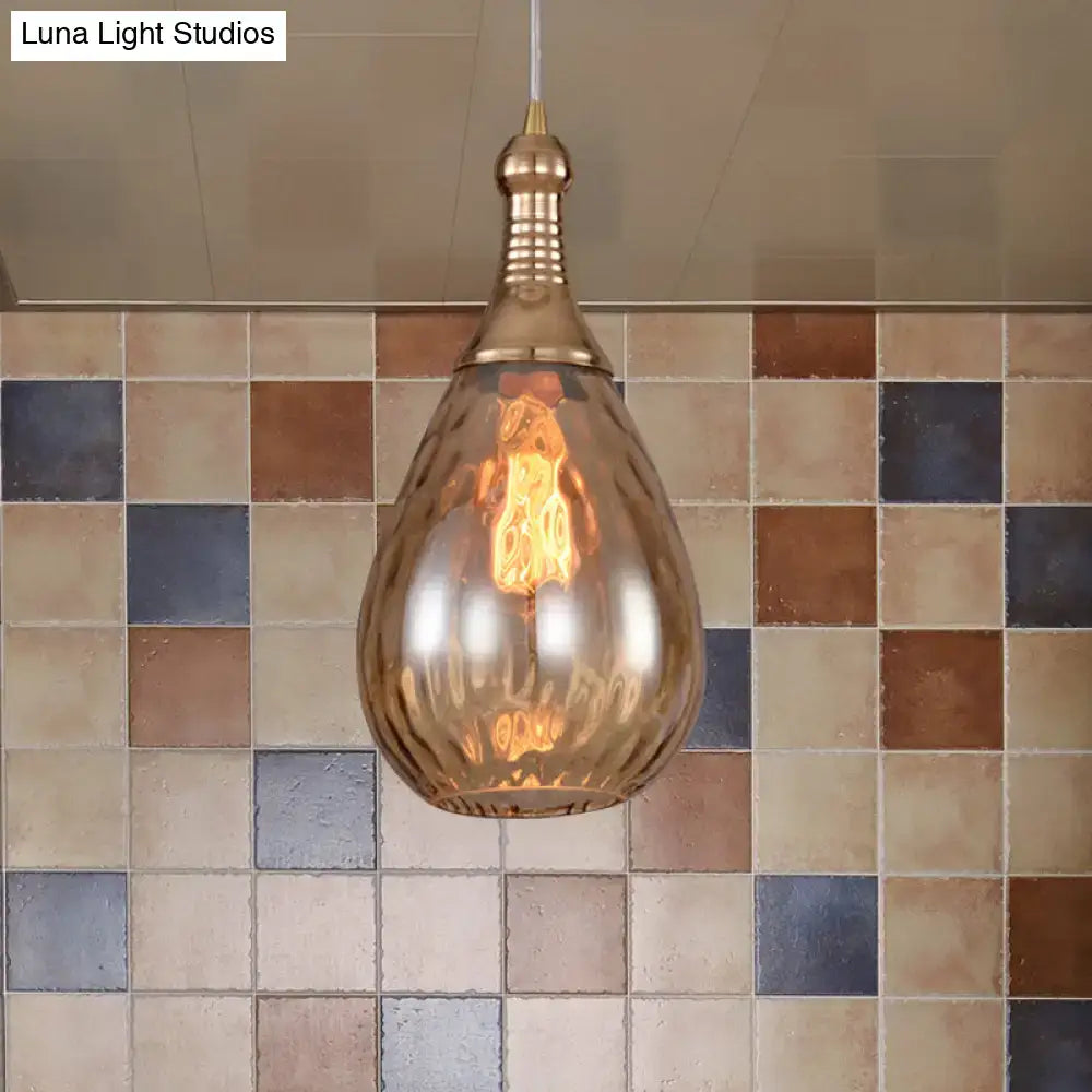A daisy industrial black ceiling light with a brass teardrop amber glass shade and exposed filament bulb