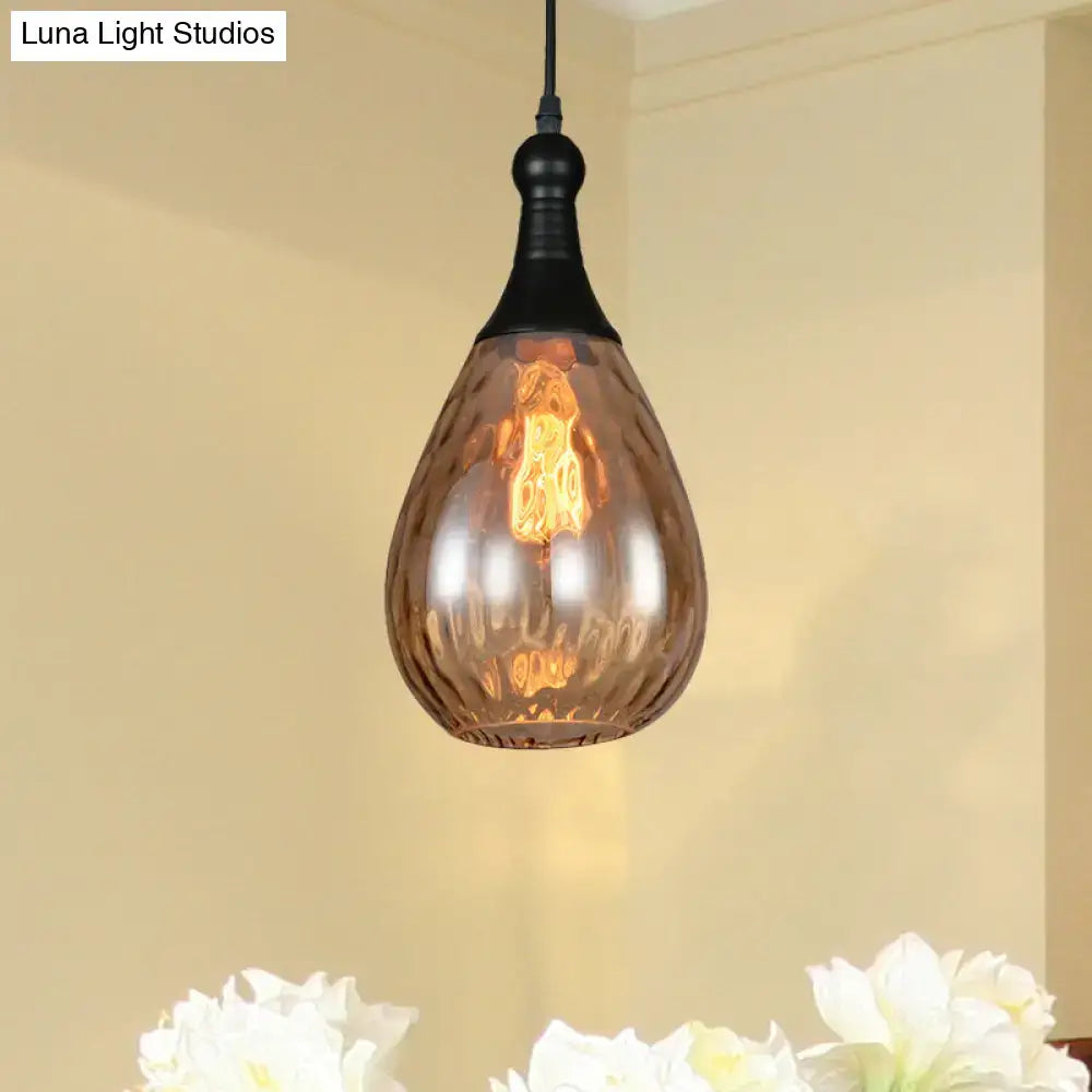 A daisy industrial black ceiling light with a teardrop-shaped amber glass pendant and black metal fixture