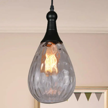 A teardrop-shaped daisy industrial black brass ceiling light with frosted textured glass and exposed edison bulb inside
