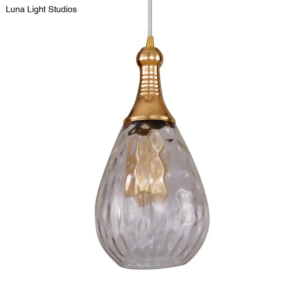 A teardrop ceiling light with textured glass and polished gold-toned top for daisy industrial black brass decor