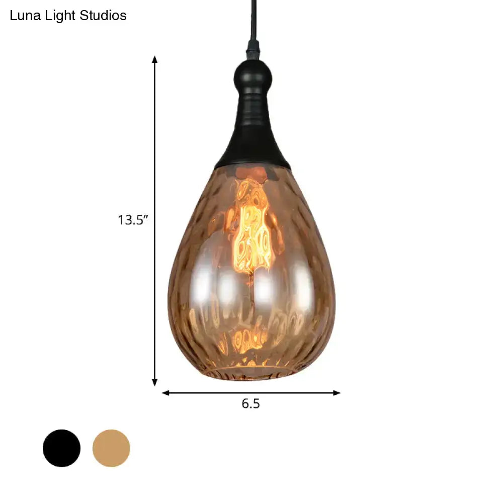 A teardrop amber glass ceiling light with black metal fixture from DecorBites daisy industrial black brass series
